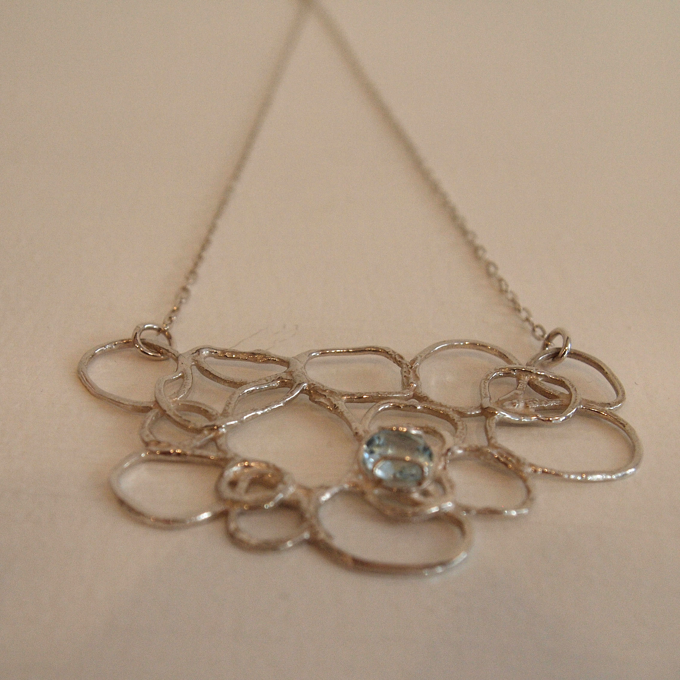 'Silver and 7mm Round Sky Blue Topaz Exposed Necklace' by artist Scarlett Erskine